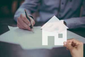 Contract being signed with house symbol in front